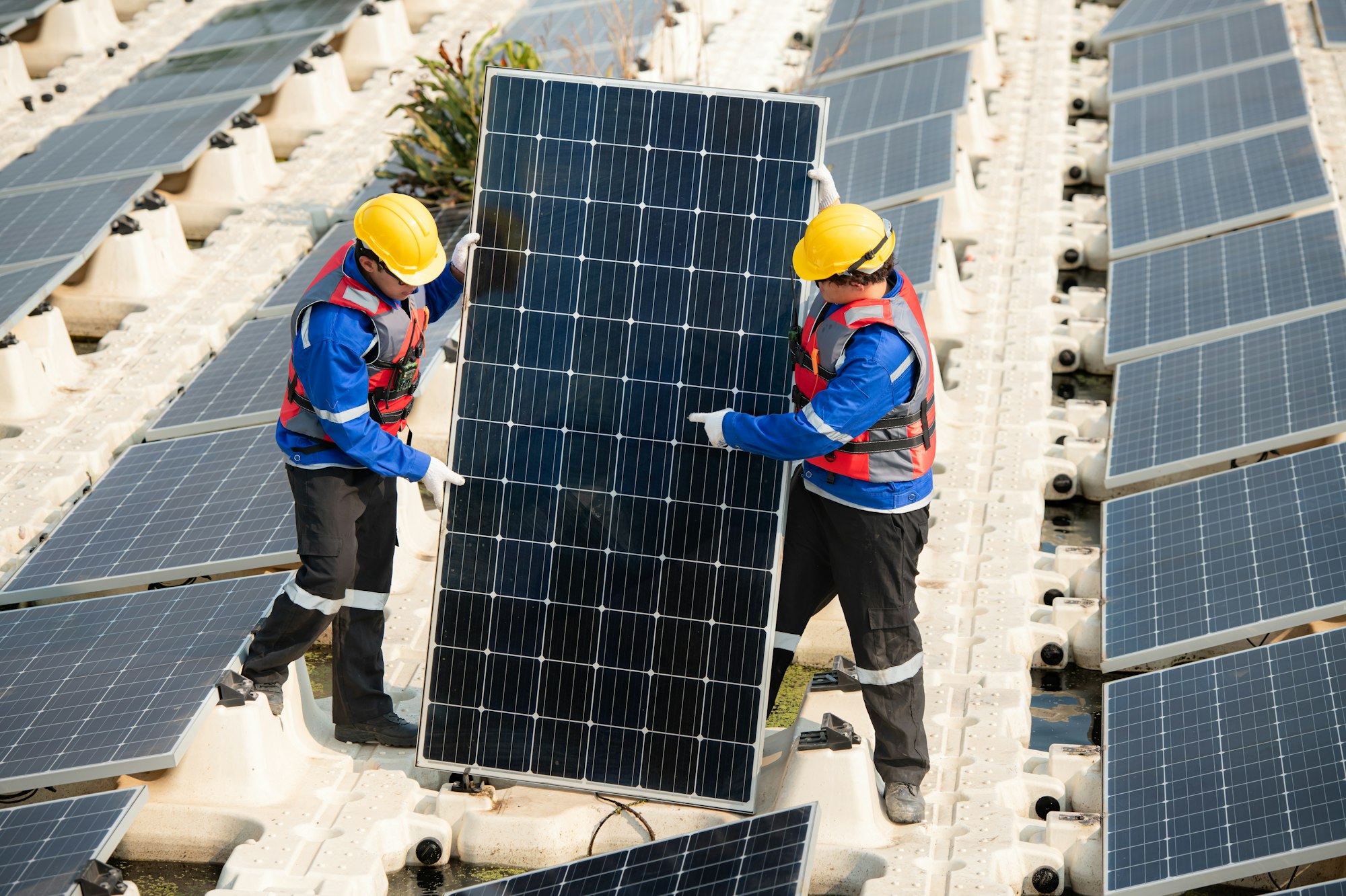 Photovoltaic engineers work on floating photovoltaics. Inspect and repair the solar panel equipment